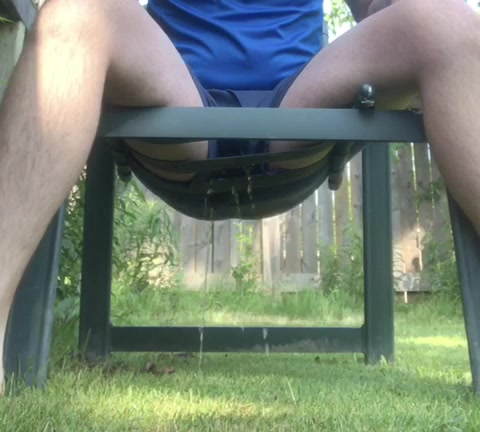 Click to play video Pissing Outside in a Chair