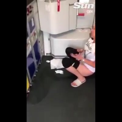 Click to play video Woman Pees on Airplane Floor