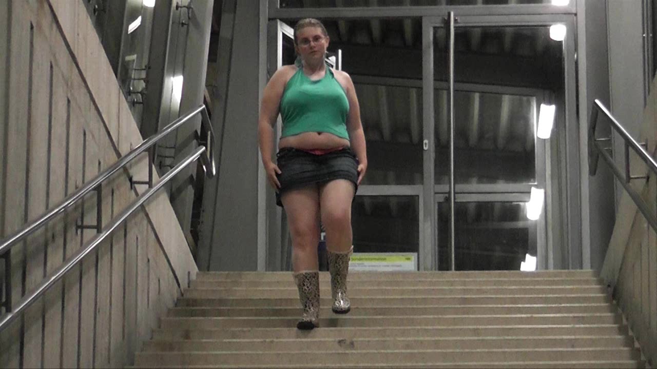 Click to play video Girl flashing at train station and pissing on stairways
